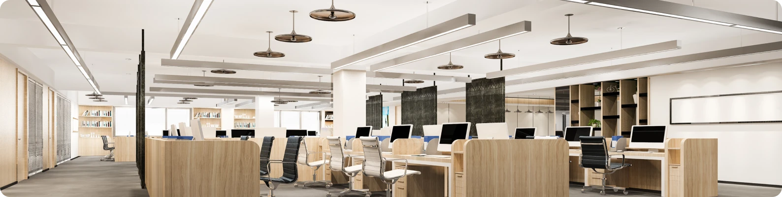 Modern office interior with wooden desks, ergonomic chairs, and bright lighting, illustrating commercial interior painting services by Trusted Painters LLC in Rockford, IL.